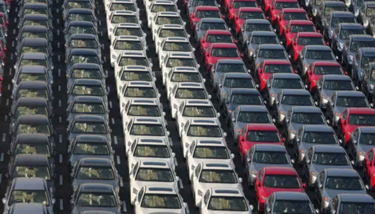 Vehicles staged on an export processing lot prepared for overseas shipping